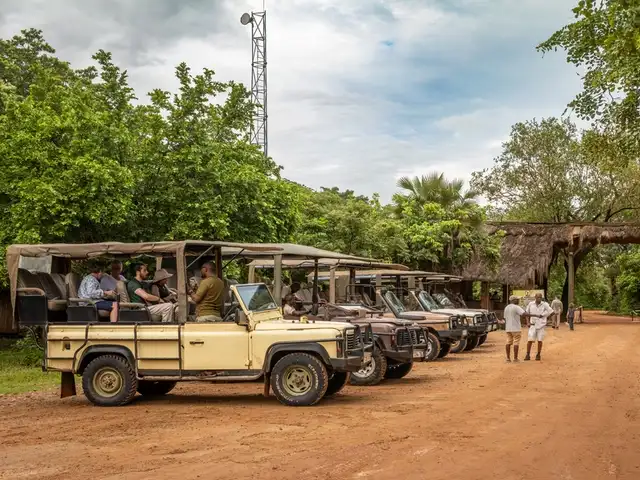 Jeep de safari alignées à l’entrée d’un parc national en Tanzanie, prêtes pour le départ